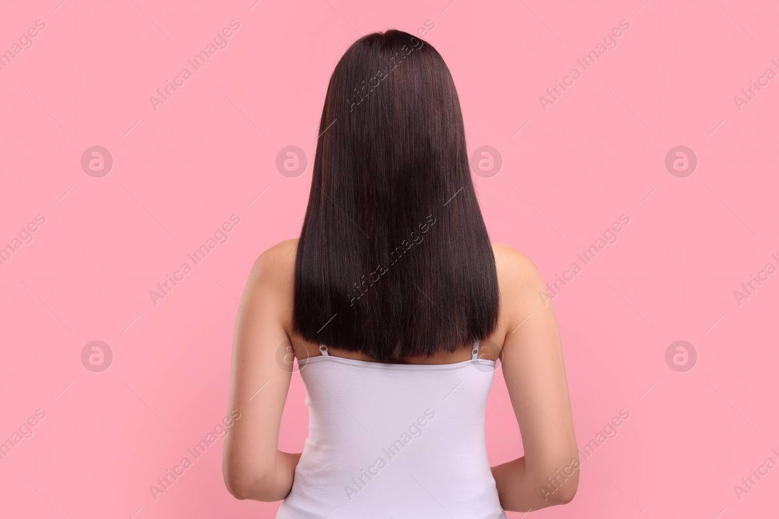 Photo of Woman with healthy hair on pink background, back view