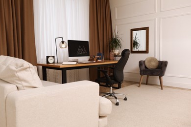 Photo of Stylish room interior with comfortable workplace near window