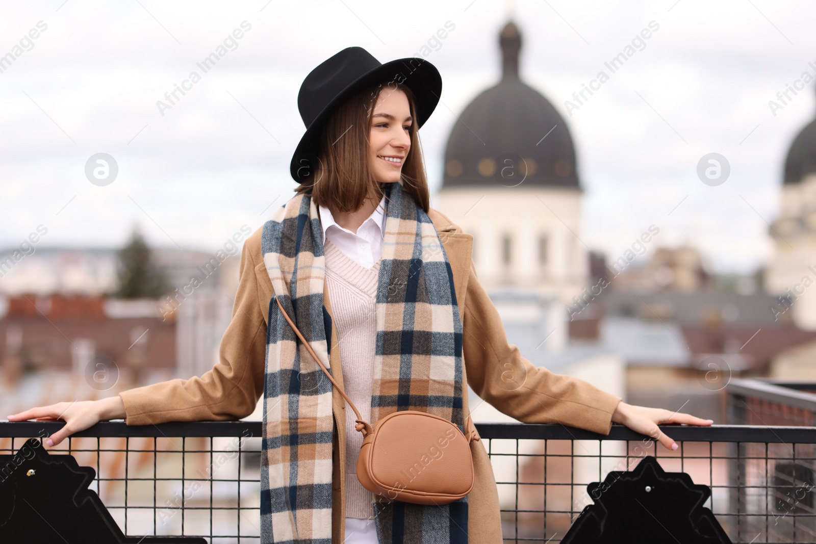 Photo of Beautiful woman in warm scarf and hat outdoors