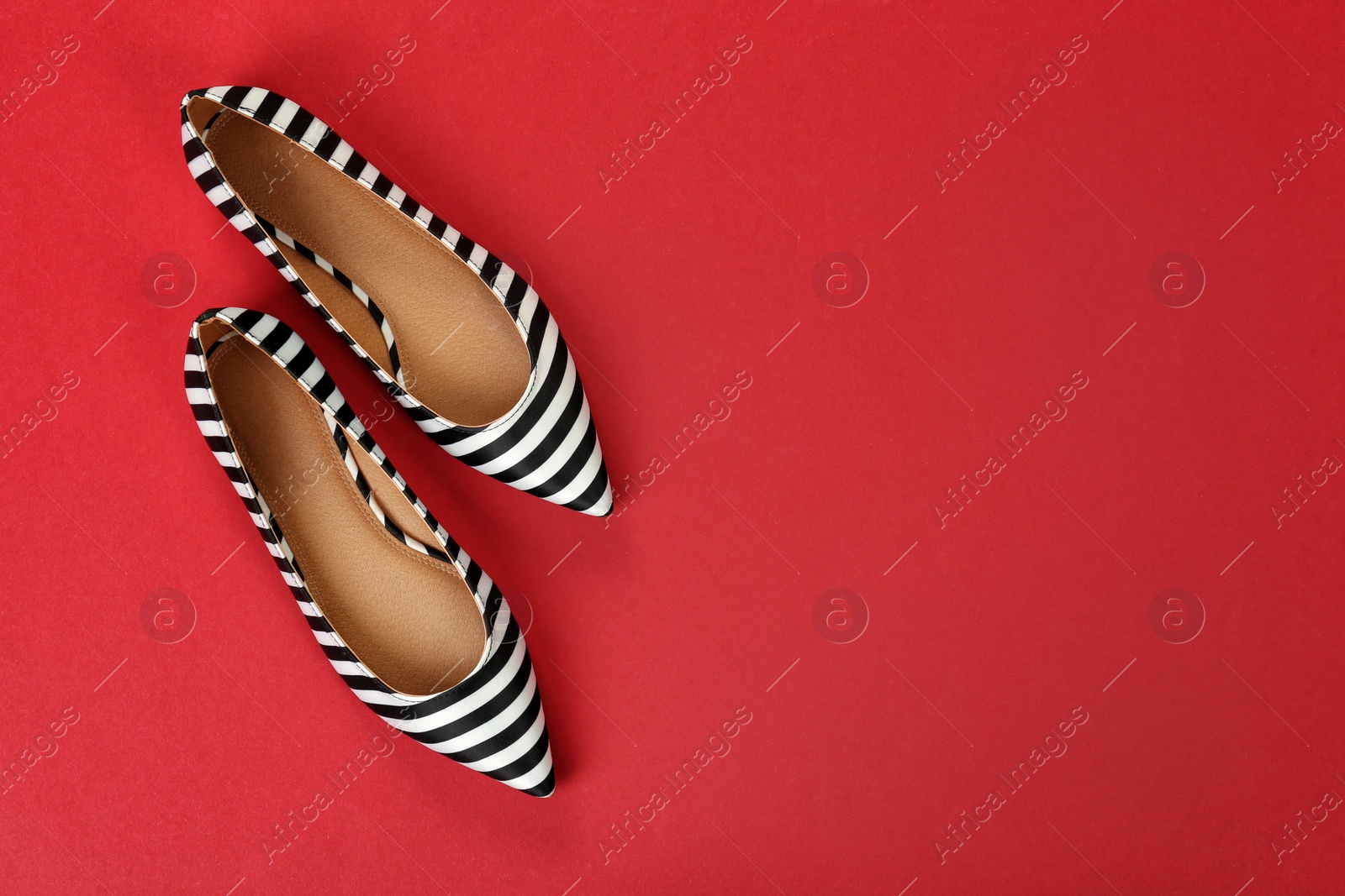 Photo of Pair of female shoes on color background, top view