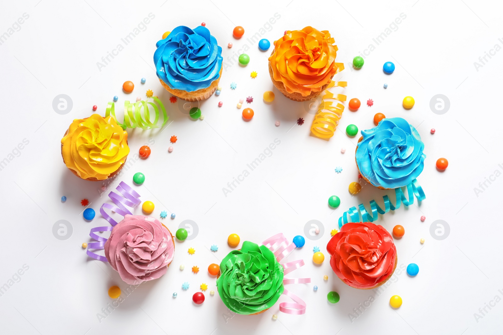 Photo of Flat lay composition with colorful birthday cupcakes on light background