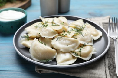Photo of Delicious dumplings on turquoise wooden table, closeup