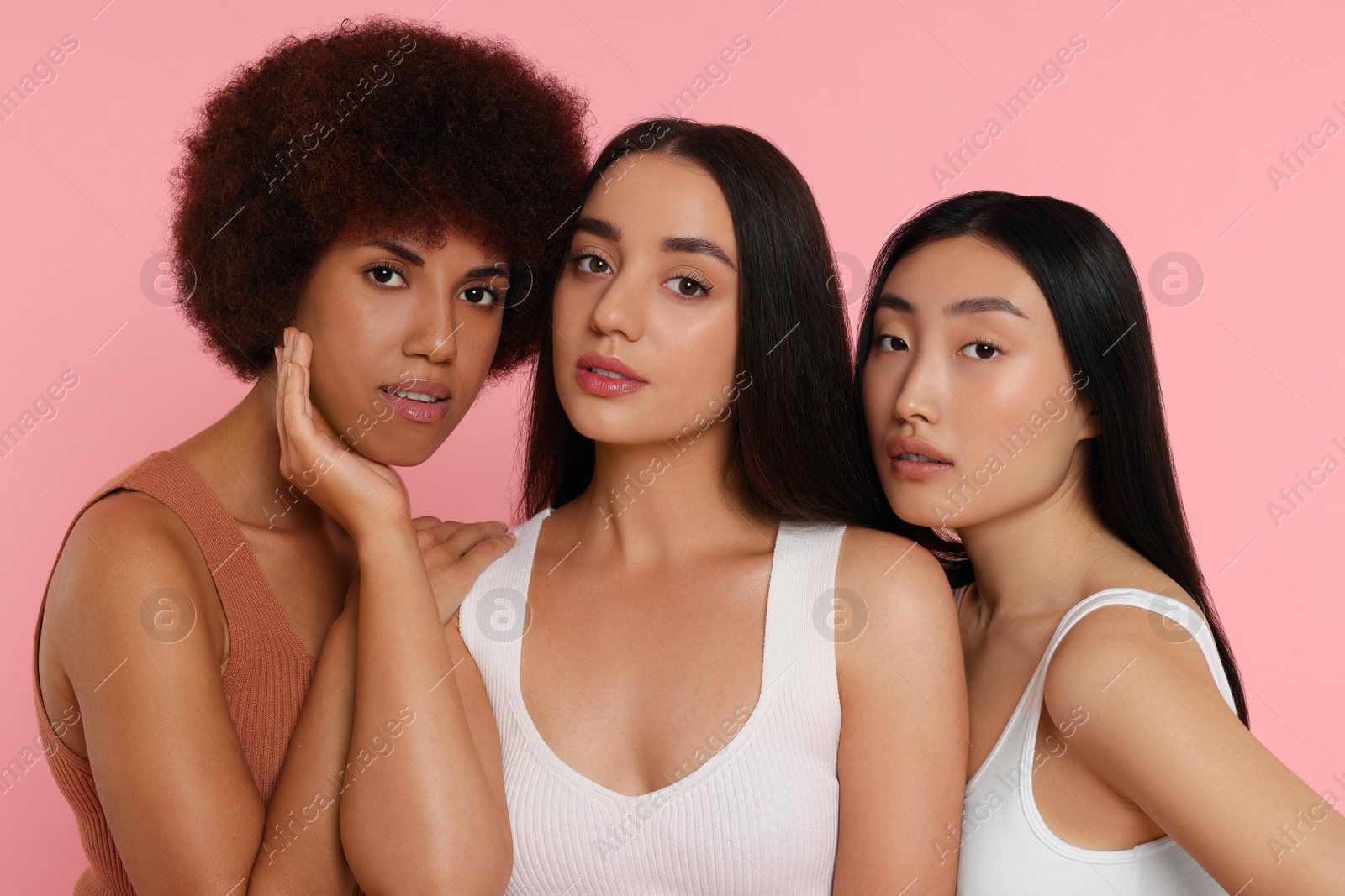 Photo of Portrait of beautiful young women on pink background