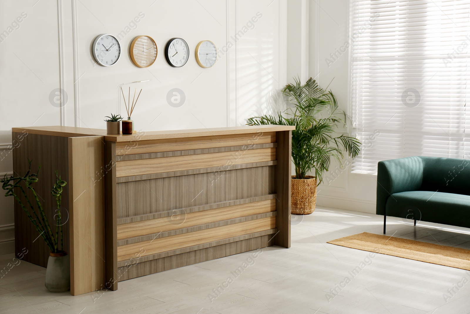 Photo of Hotel lobby interior with wooden reception desk. Stylish workplace