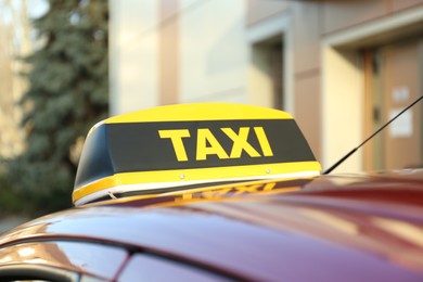 Photo of Roof light with word TAXI on car outdoors