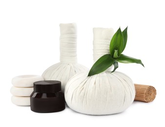 Photo of Herbal massage bags and other spa products on white background