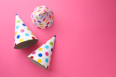 Photo of Beautiful party hats on pink background, top view. Space for text