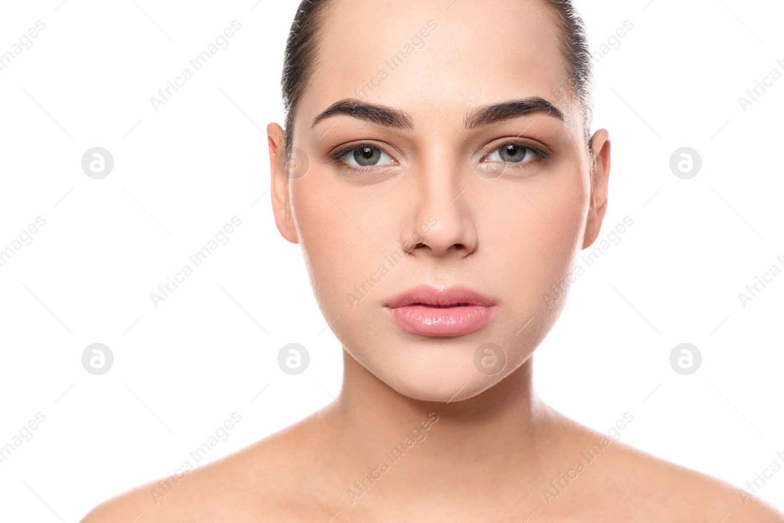 Photo of Portrait of young woman with beautiful face and natural makeup on white background