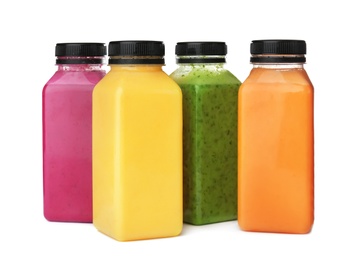 Photo of Bottles with delicious detox smoothies on white background