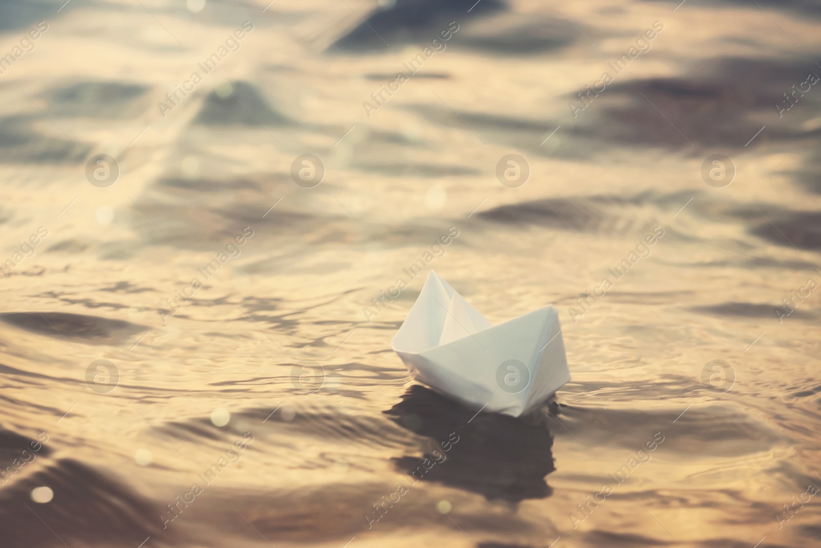 Image of White paper boat floating on river. Retro photo effect