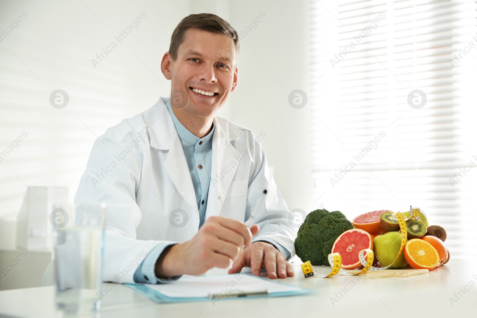 Photo of Nutritionist working at desk in his office