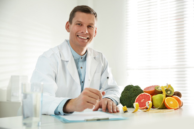 Nutritionist working at desk in his office