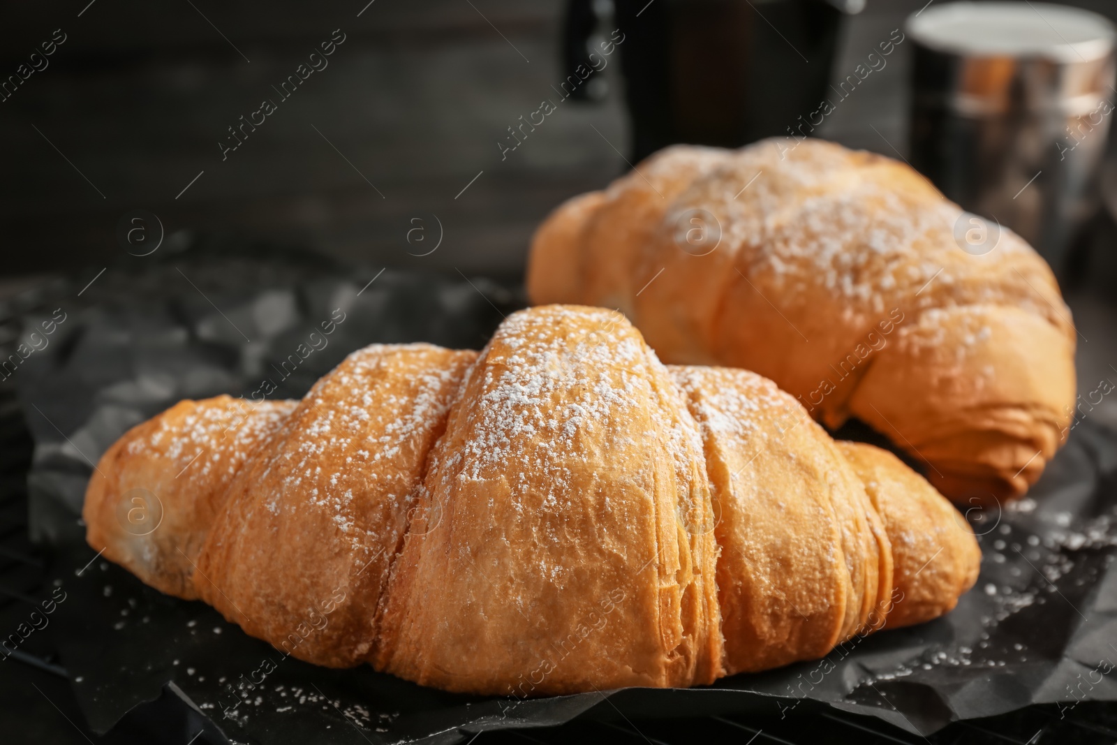 Photo of Tasty croissants with sugar powder, closeup