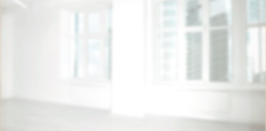 Empty room with white wall and windows, blurred view. Banner design