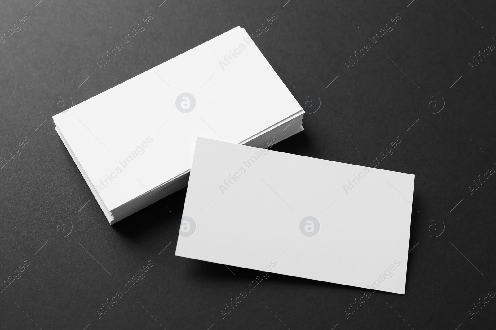 Photo of Blank business cards on black background, above view. Mockup for design