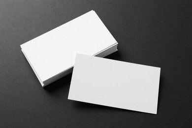 Photo of Blank business cards on black background, above view. Mockup for design