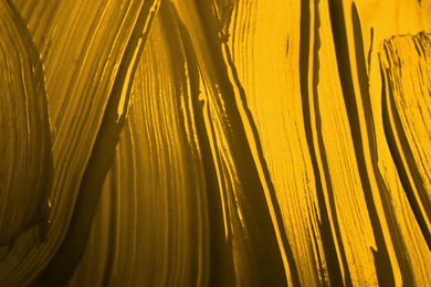 Image of Golden paint strokes as background, top view