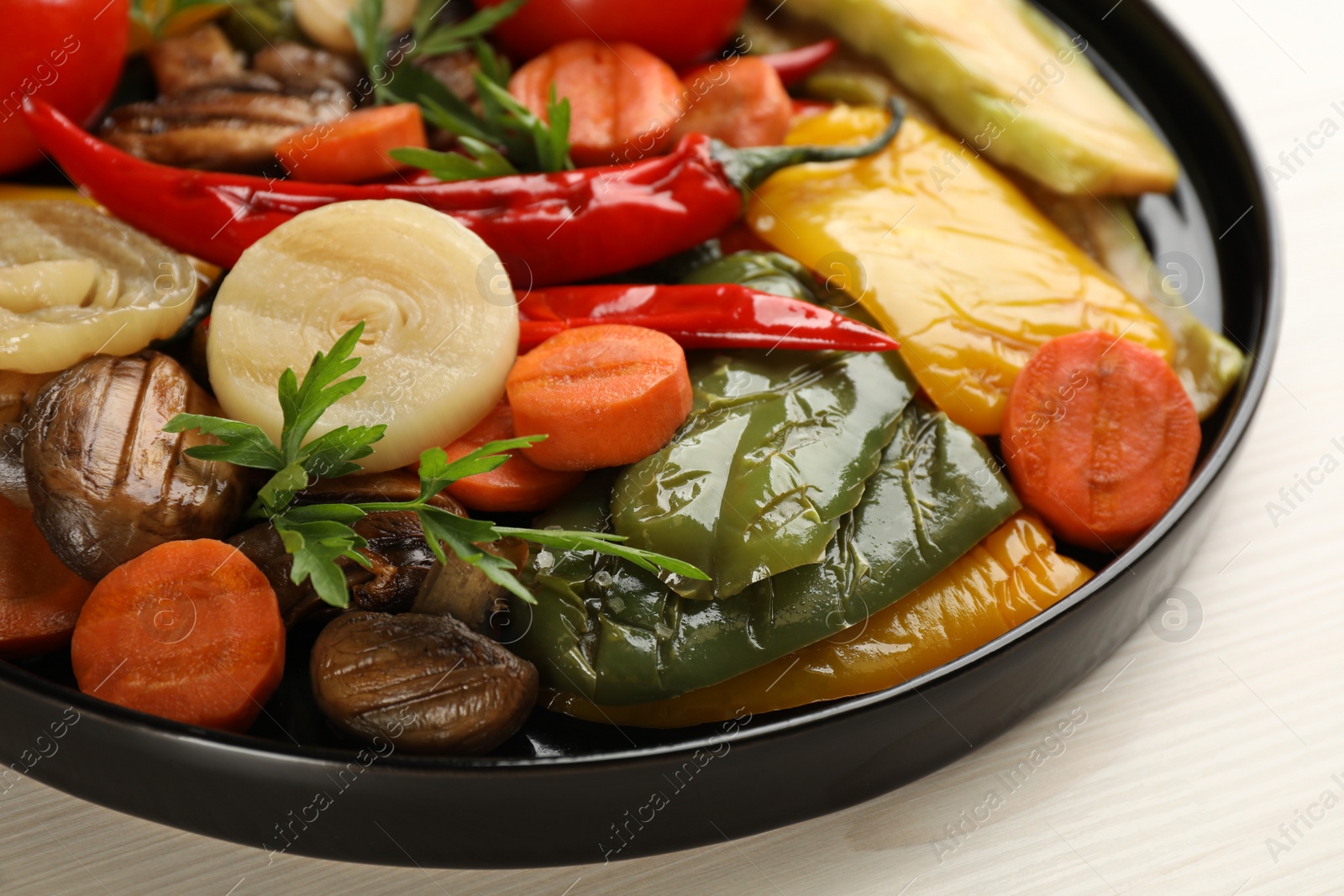 Photo of Delicious grilled vegetables with parsley on white wooden table, closeup