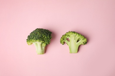 Photo of Fresh green broccoli on color background, flat lay