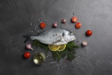 Fresh dorado fish and ingredients on grey table, flat lay