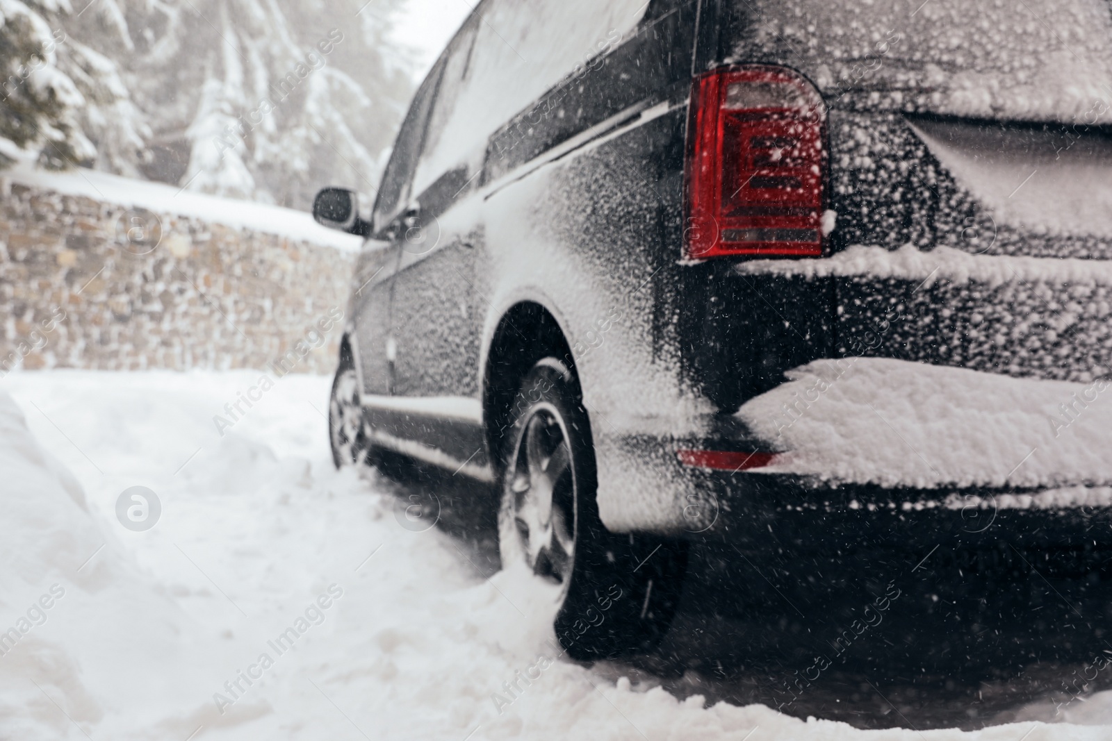 Photo of Modern car covered with snow outdoors on winter day, closeup