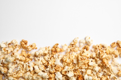 Photo of Delicious caramel popcorn on white background, top view