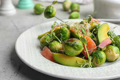 Photo of Tasty salad with Brussels sprouts on grey table, closeup