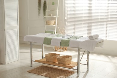 Stylish spa salon interior with massage table