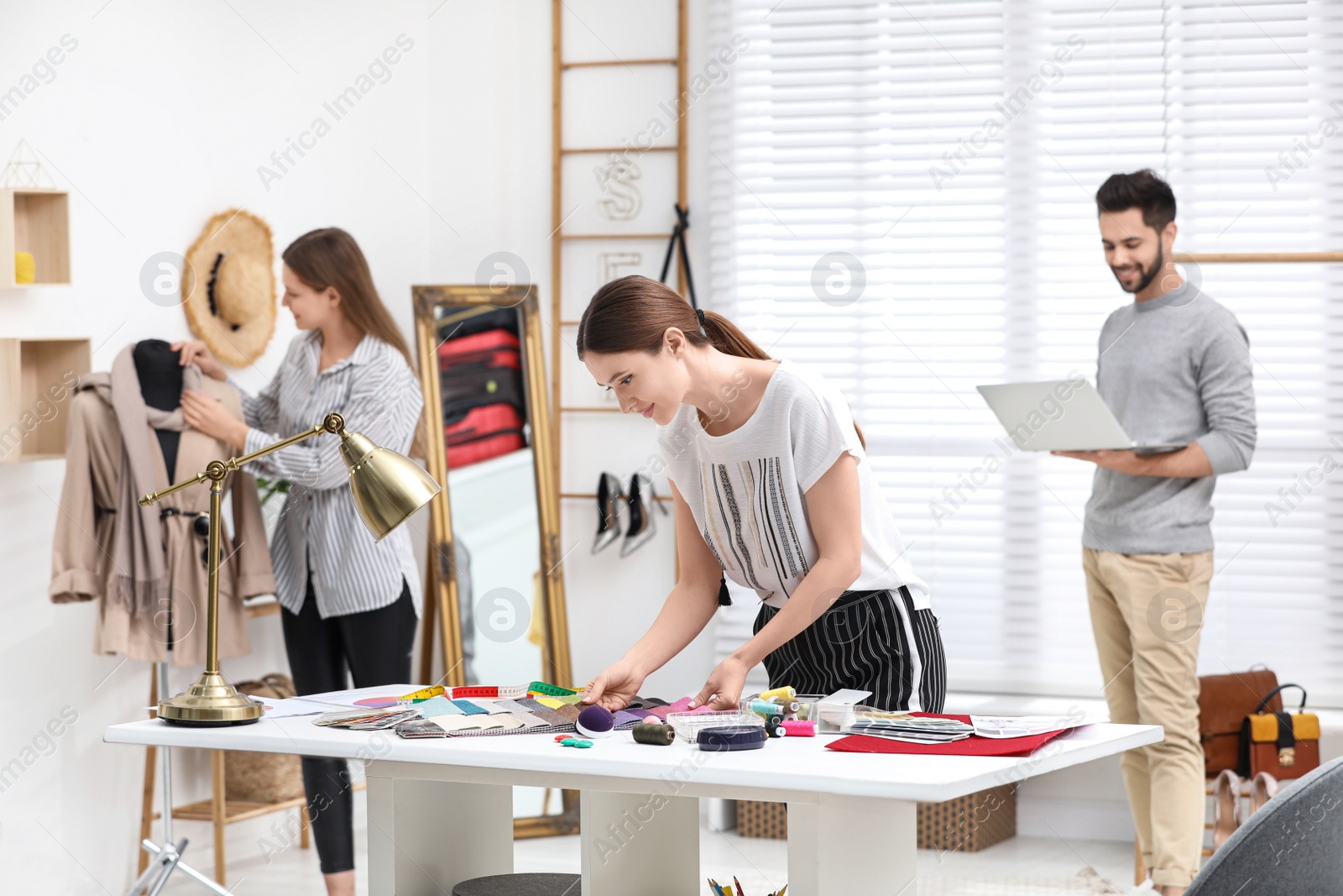 Photo of Fashion designers creating new clothes in studio