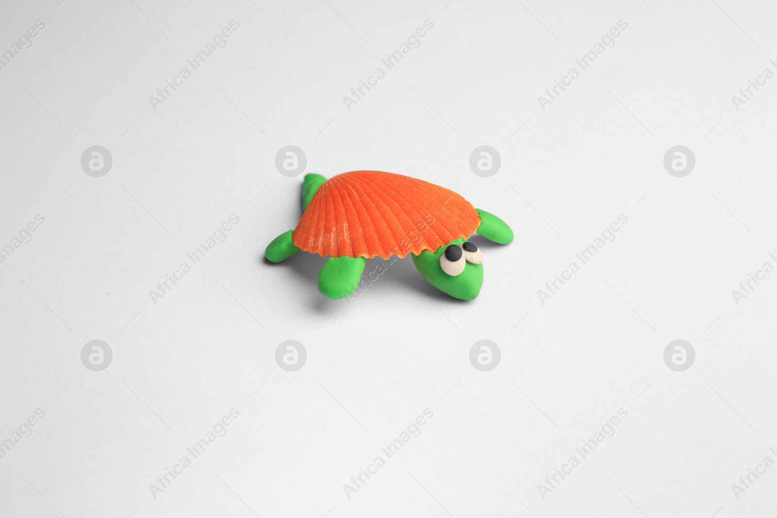 Photo of Beautiful plasticine turtle isolated on white. Children's handmade ideas