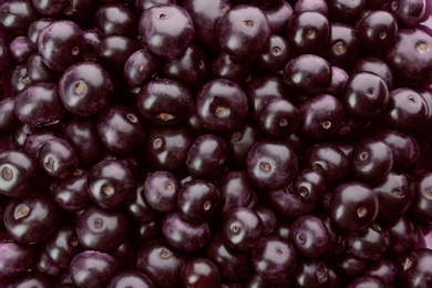 Photo of Fresh ripe acai berries as background, closeup