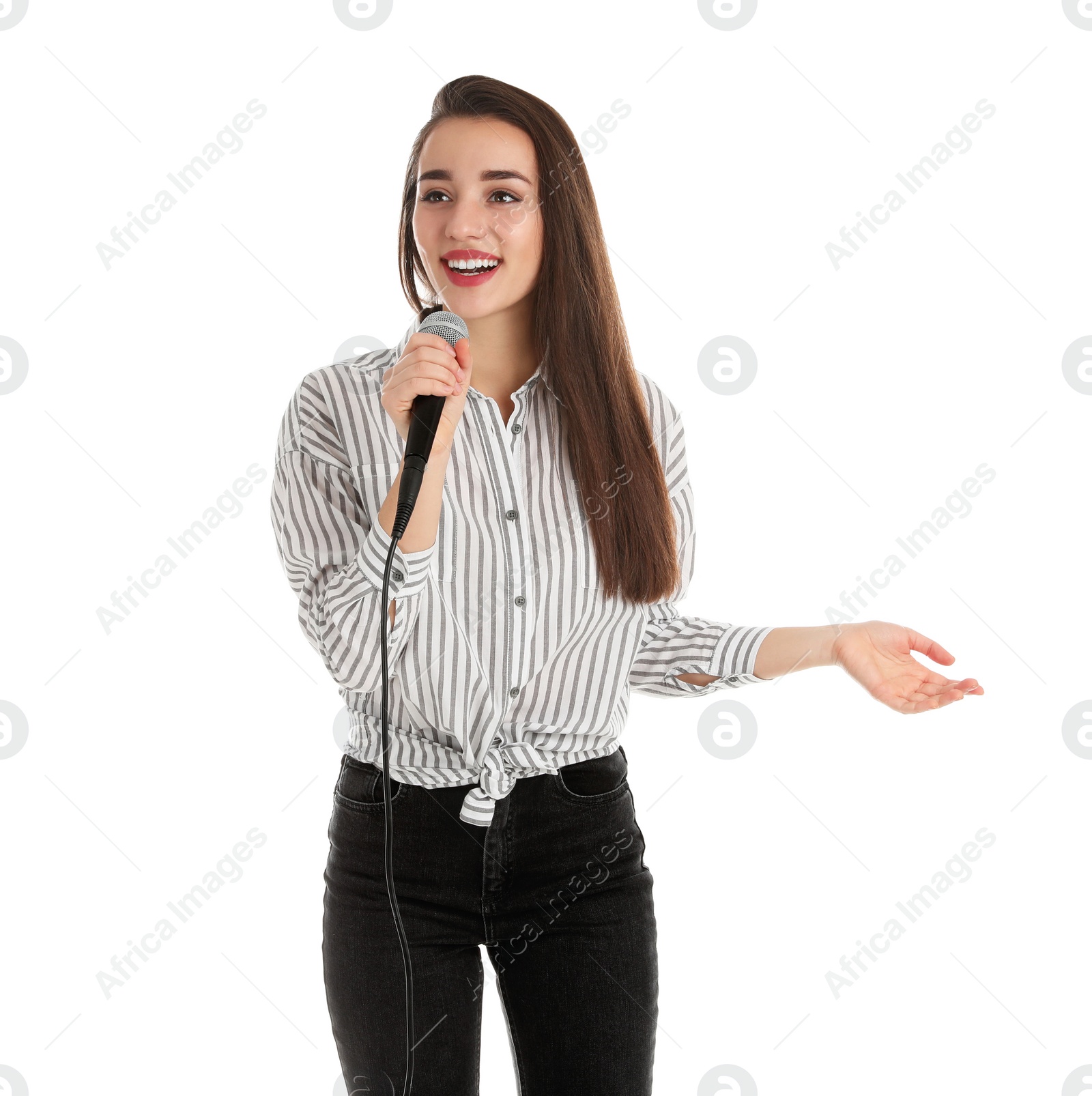 Photo of Young woman in casual clothes posing with microphone on white background