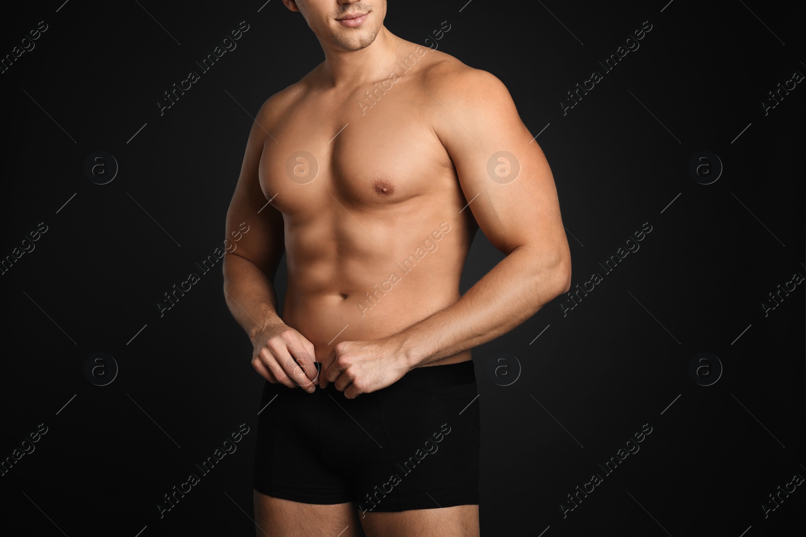 Photo of Man with sexy body on grey background, closeup