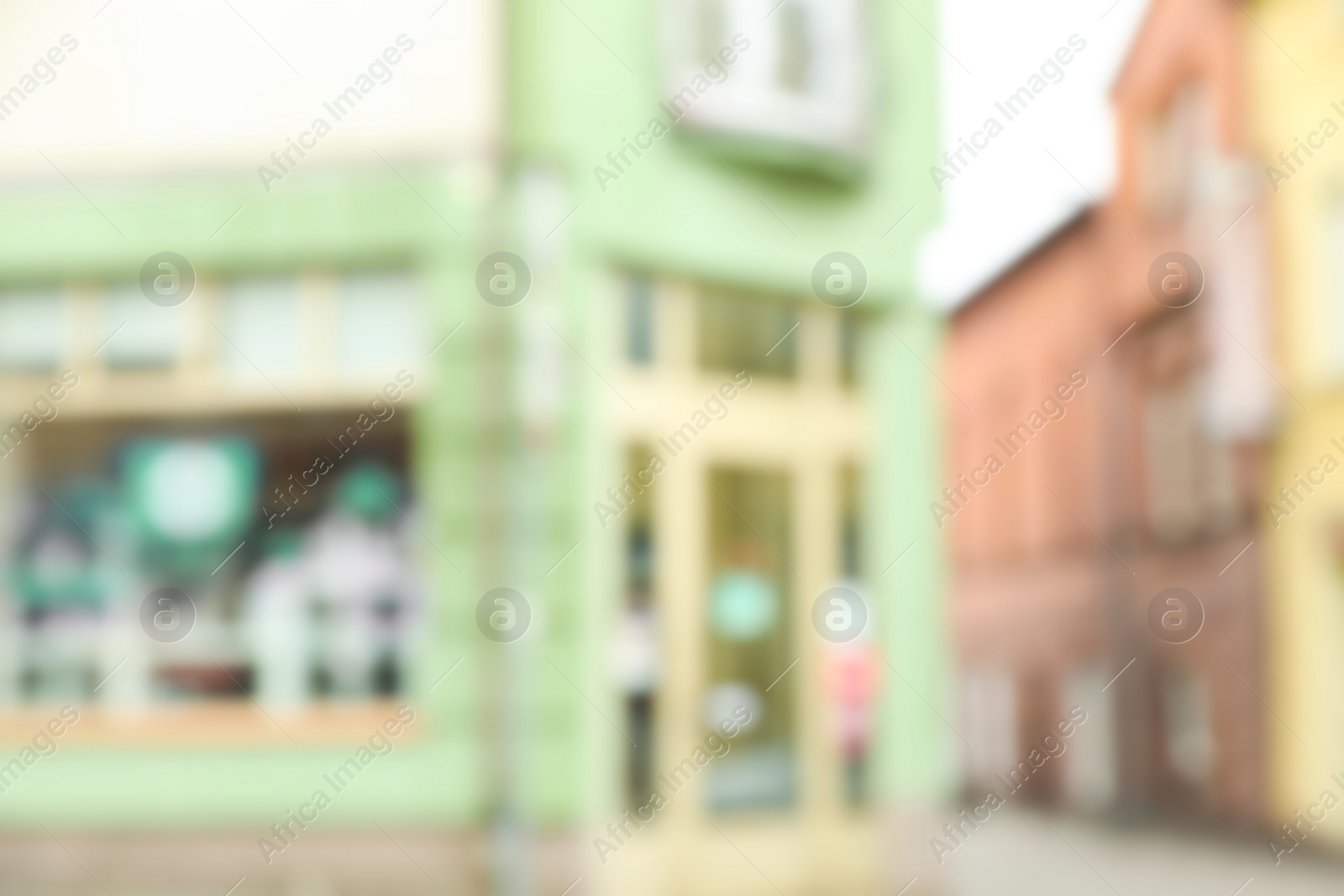 Photo of Blurred view of city street with modern store. Bokeh effect