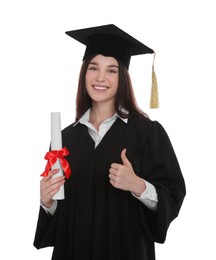 Photo of Happy student in academic dress with diploma showing thumb up on white background