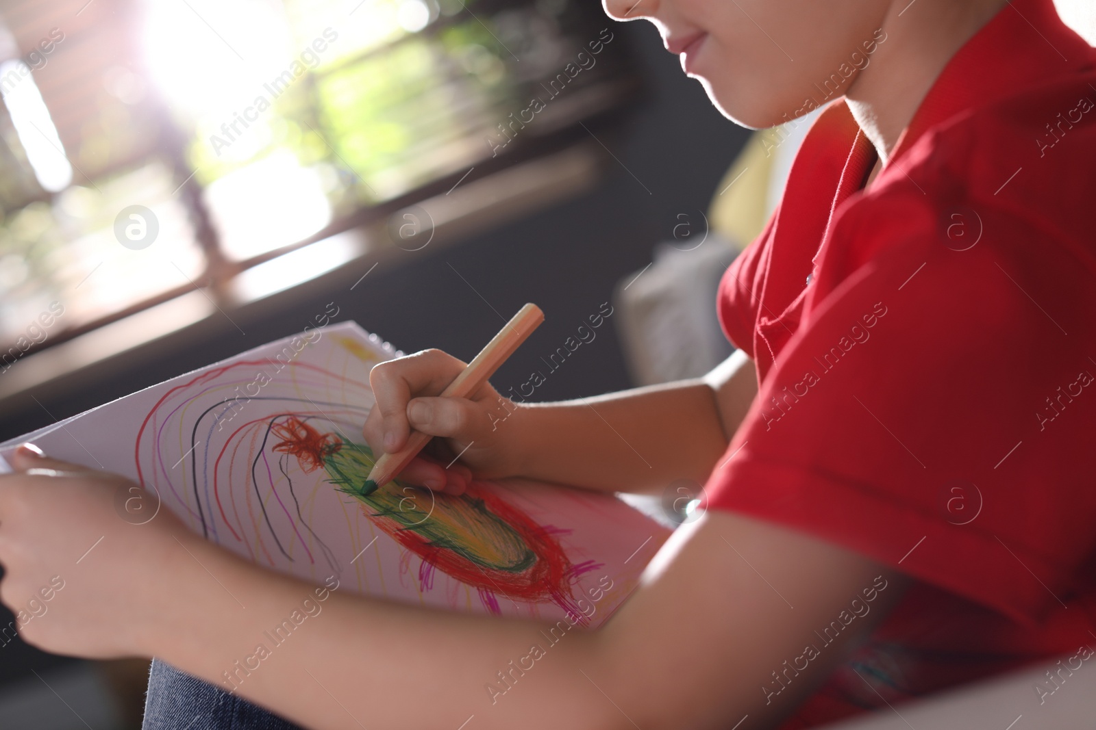 Photo of Little boy drawing at home, closeup. Creative hobby