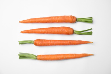 Photo of Ripe fresh carrots on white background