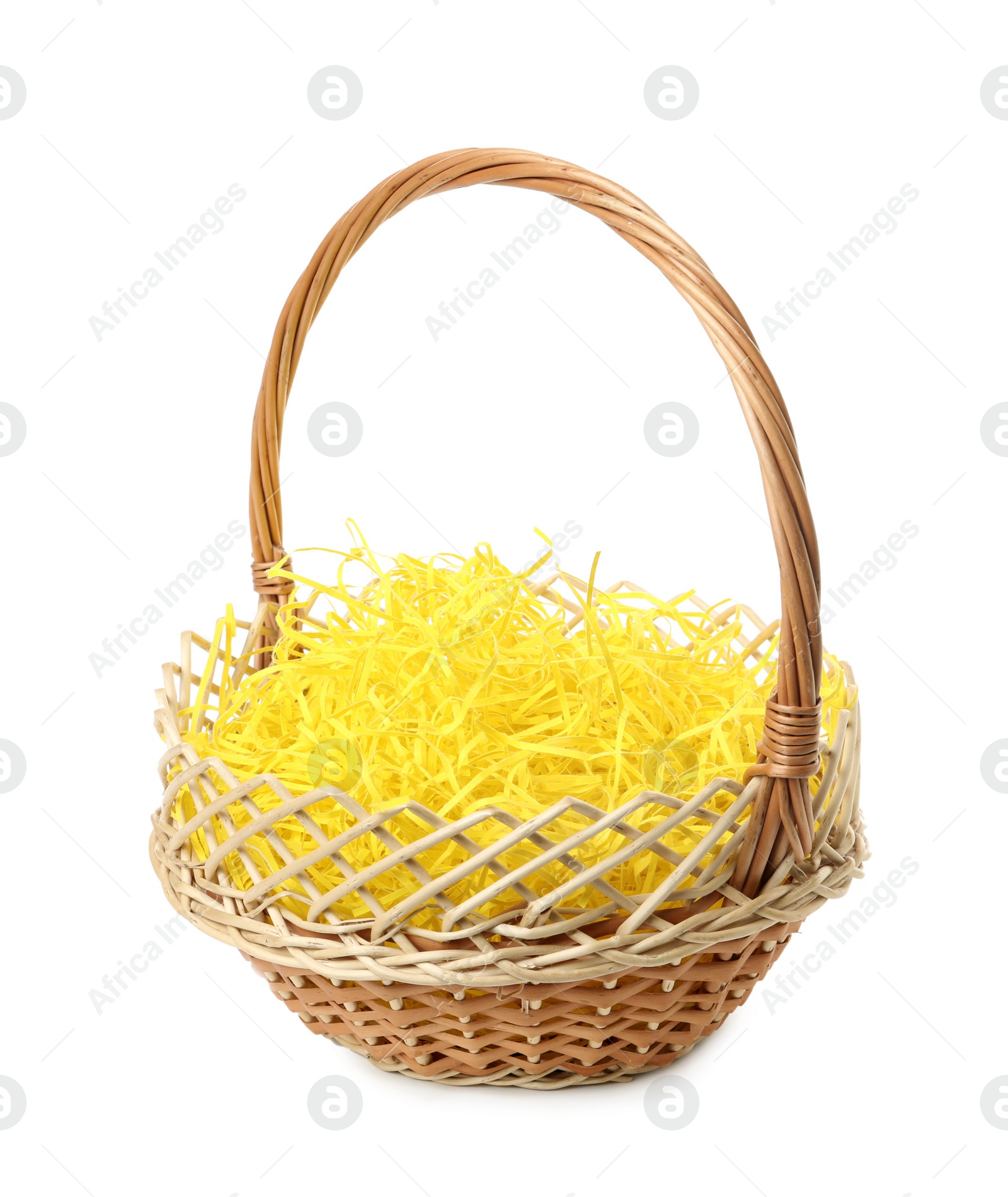 Photo of Wicker basket with yellow filler isolated on white. Easter item