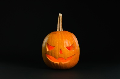 Pumpkin head on black background. Jack lantern - traditional Halloween decor