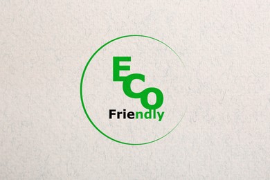 Image of Phrase Eco Friendly written on recycled paper, top view