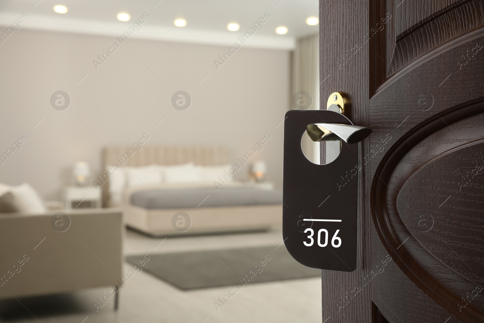 Image of Wooden door open into modern hotel room, closeup