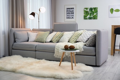 Photo of Beautiful room interior with comfortable sofa