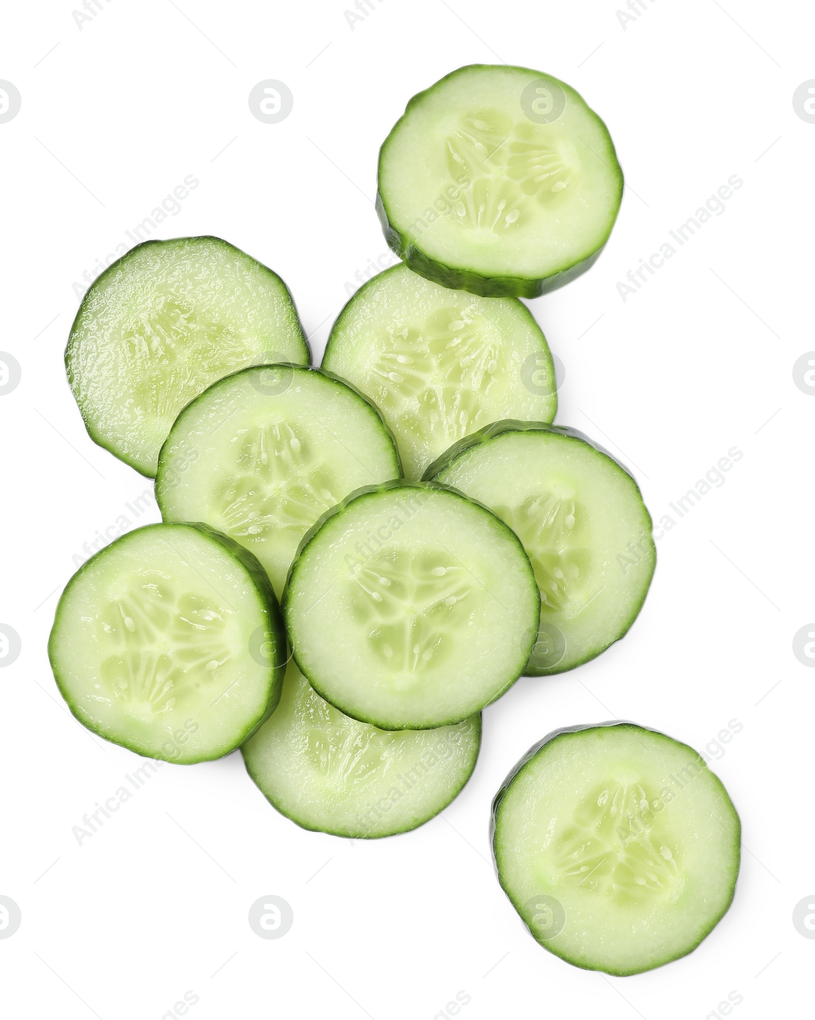 Photo of Pile of fresh cut cucumber isolated on white, top view