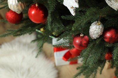 Closeup view of beautifully decorated Christmas tree indoors, space for text