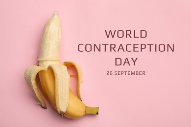 Image of World contraception day. Banana with condom on pink background, top view