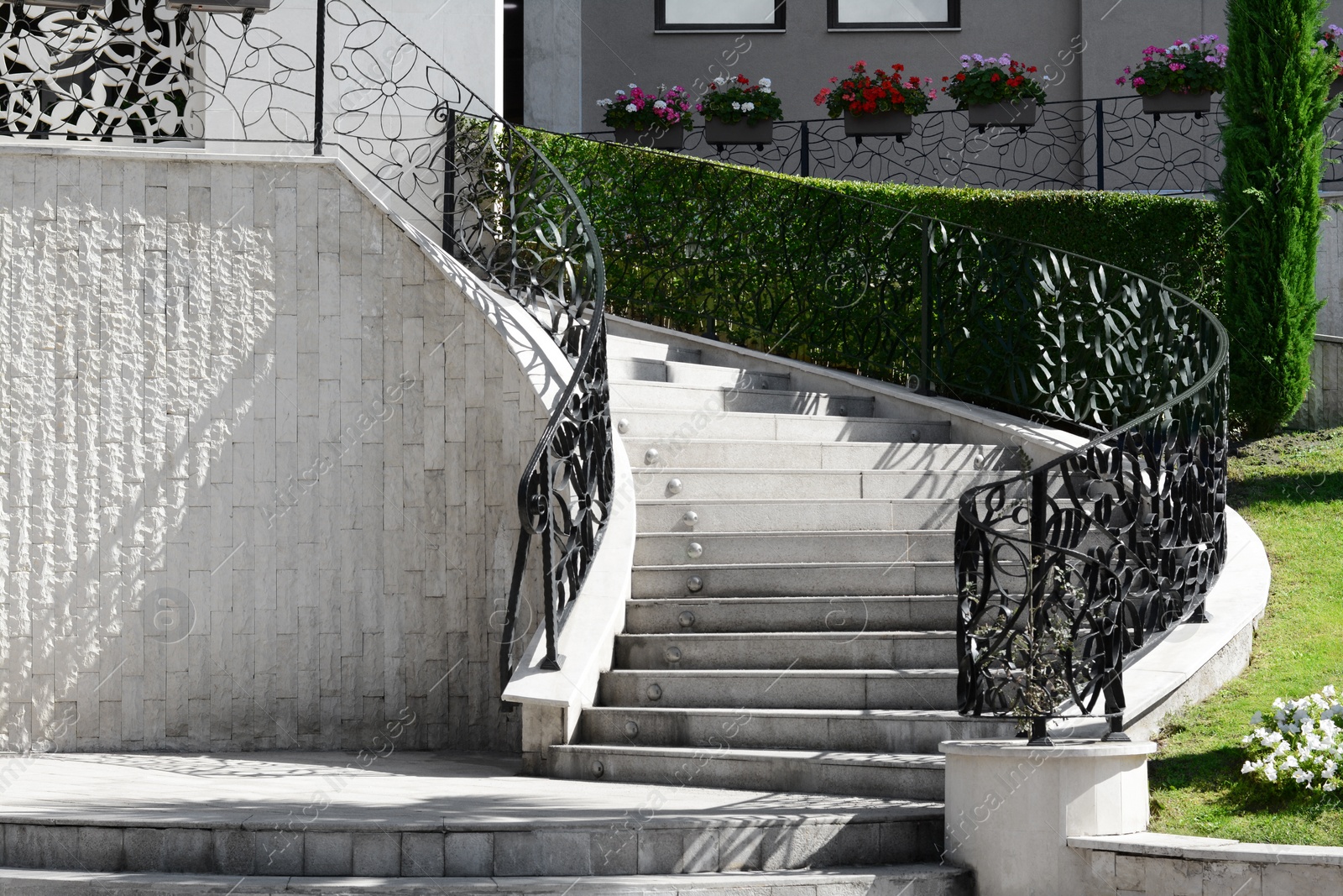 Photo of Staircase with beautiful ornate handrails outdoors on sunny day