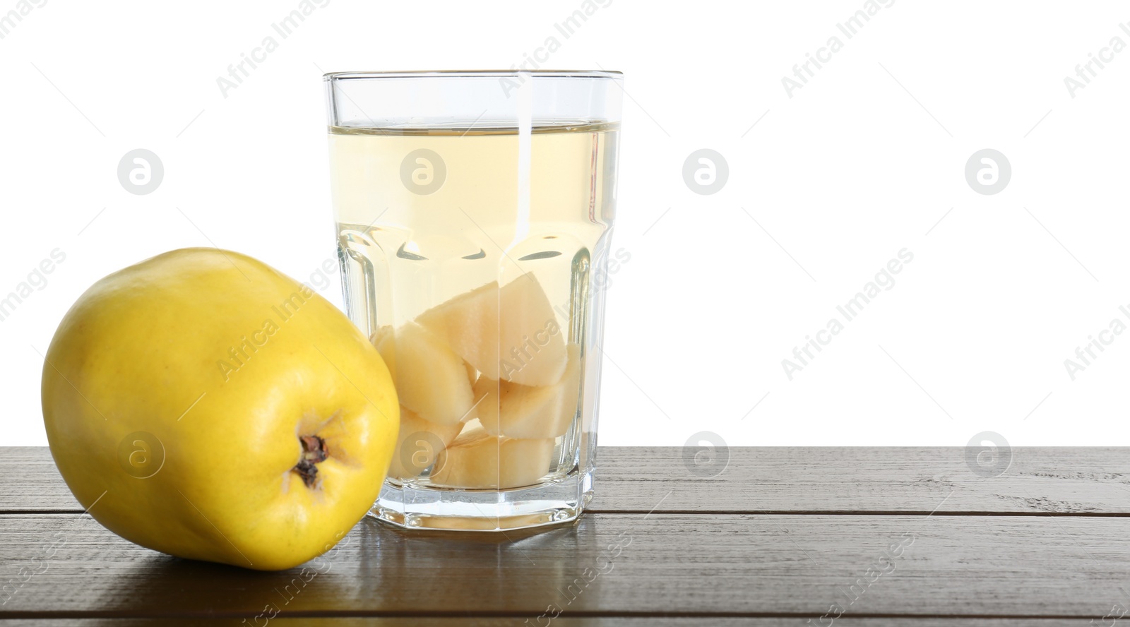 Photo of Delicious quince drink and fresh fruit on wooden table against white background