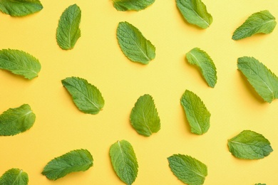 Photo of Fresh mint leaves on yellow background, flat lay