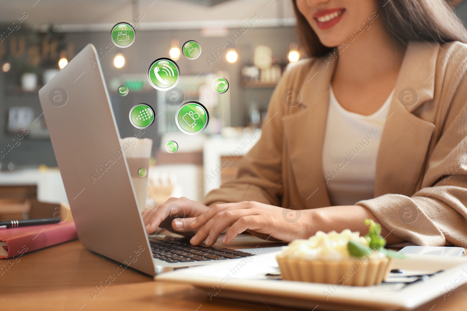 Image of Young woman using laptop in cafe, closeup. Social media