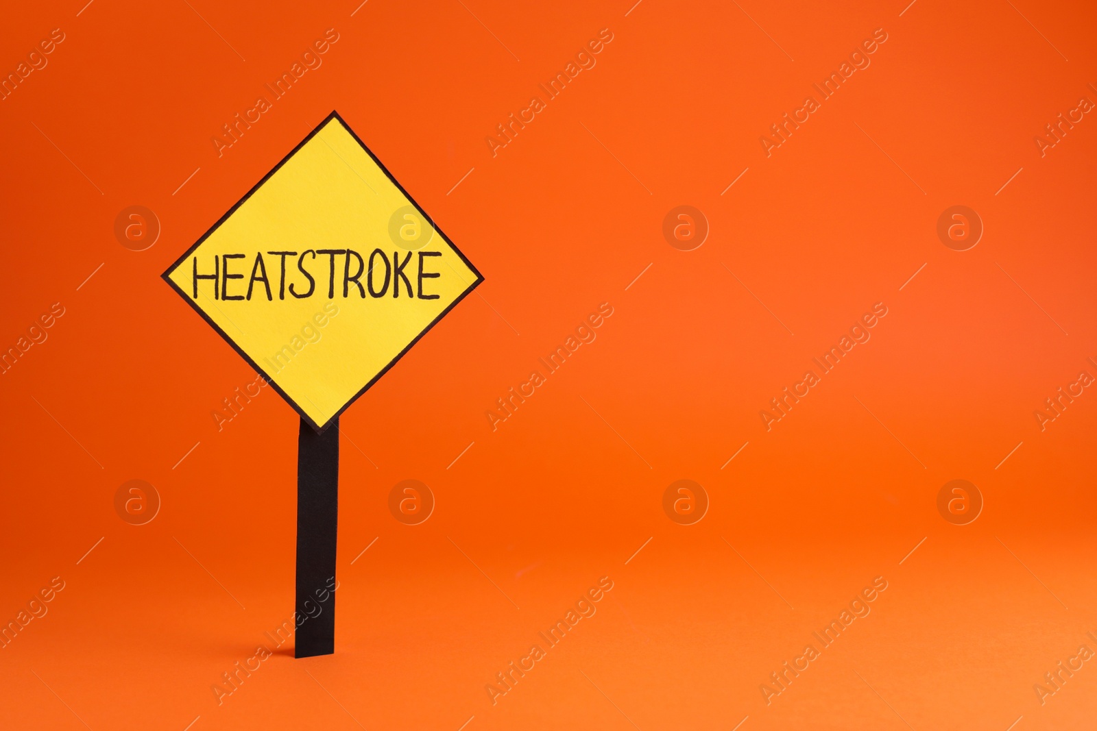Photo of Sign with words Heat Stroke on orange background, space for text